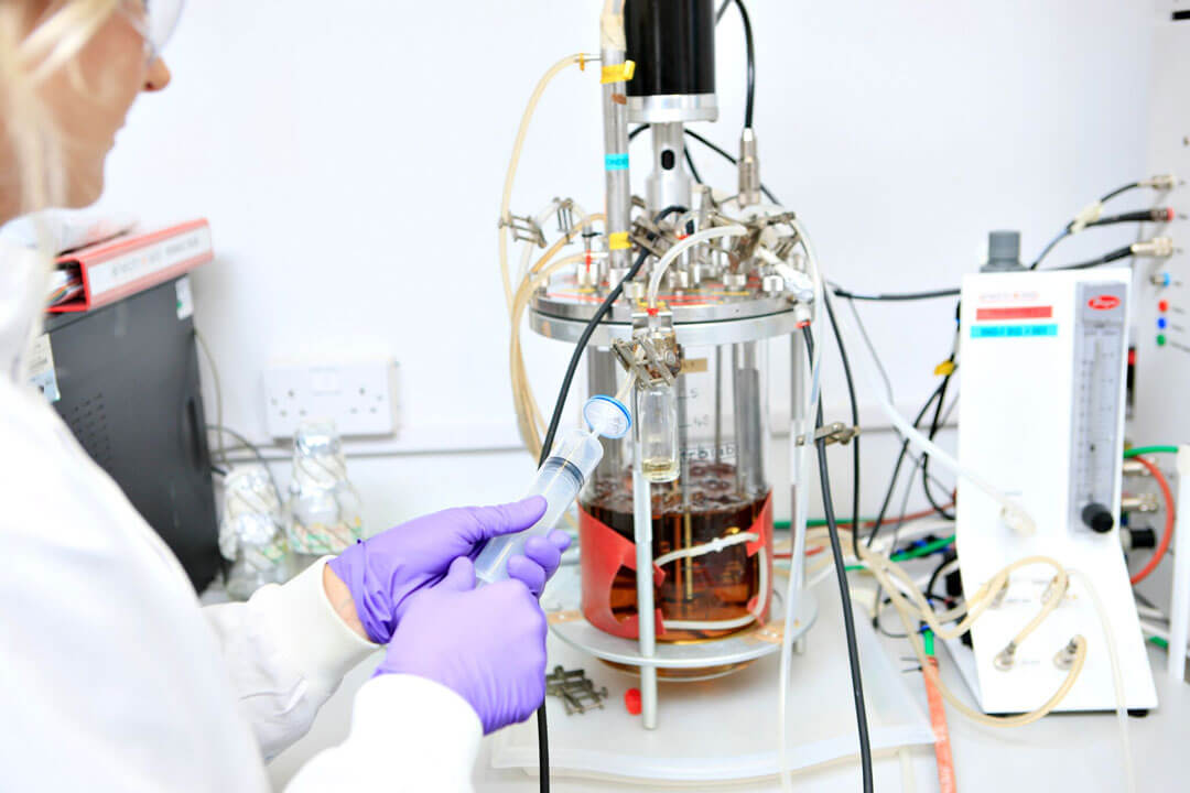 Scientist with a fermenter